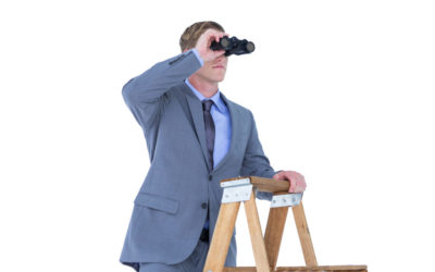 Businessman using binoculars against a white background
